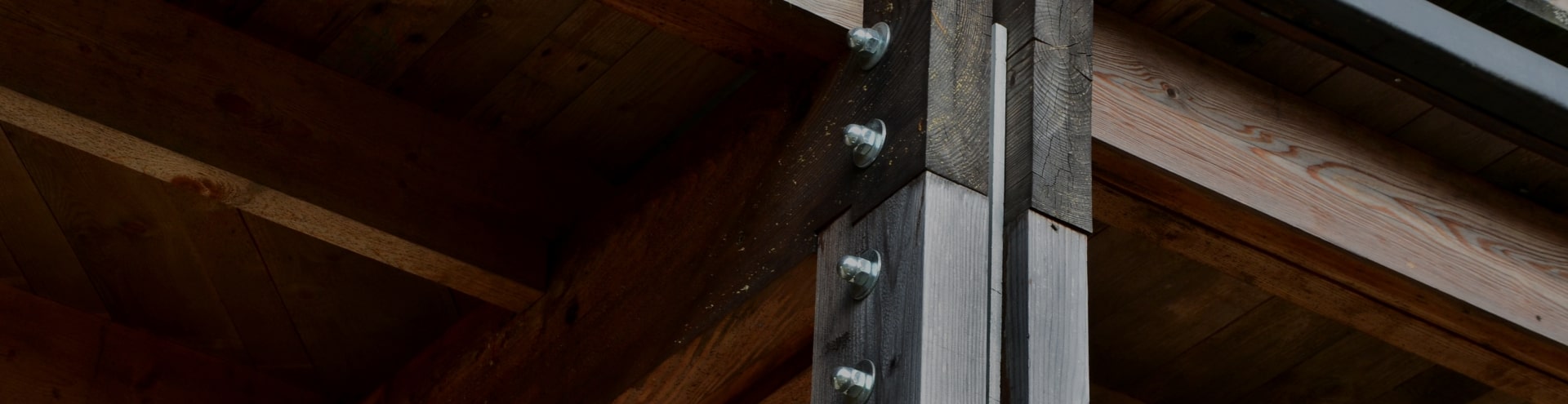A close up of screws in wood beams