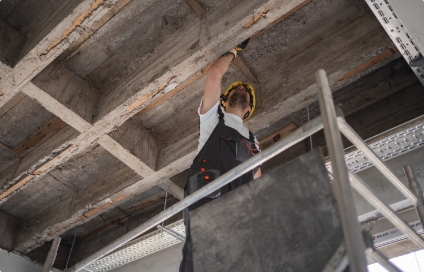 A construction worker on a lift, working on a roof