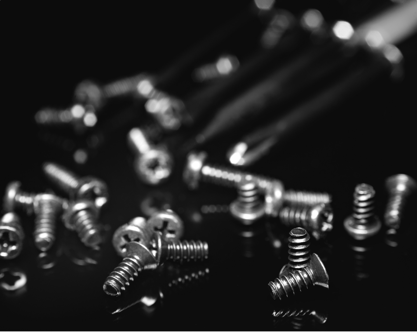 A close up of multiple screws falling