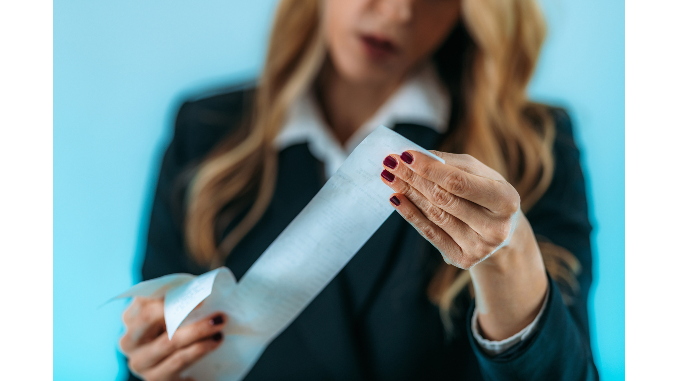 a woman with red nails looking at a receipt